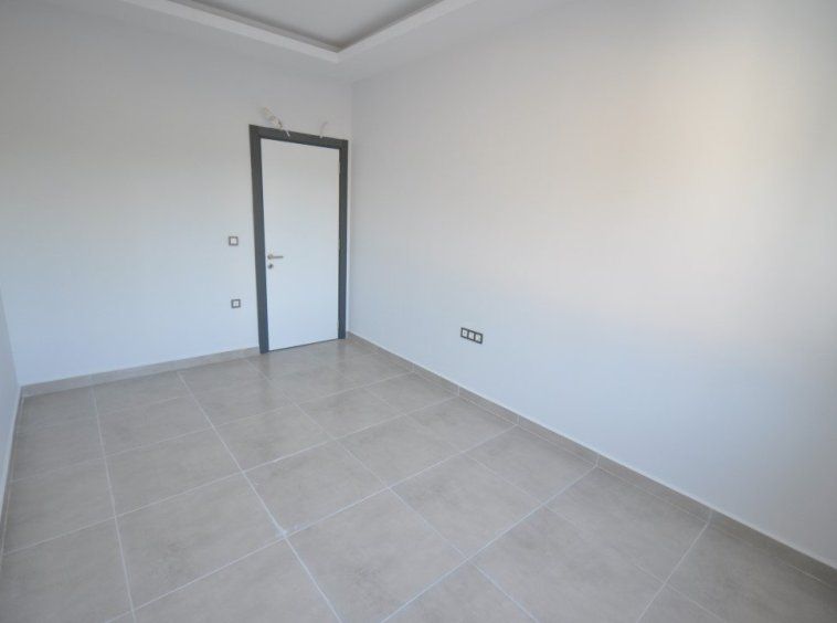 Новая квартира 1+1 без мебели в Махмутларе - Алания