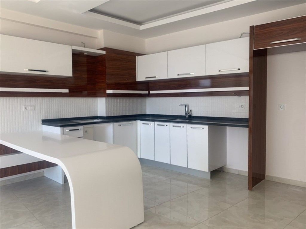 Новые квартиры 1+1 без мебели в Махмутлар